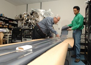 Erten Eser (left) and Shannon Fields work on the largest, most flexible solar panel manufactured to date.  Eser and Fields belong to the Institute for Energy Conversion. UDaily article: http://www.udel.edu/PR/UDaily/2007/mar/solar032307.html